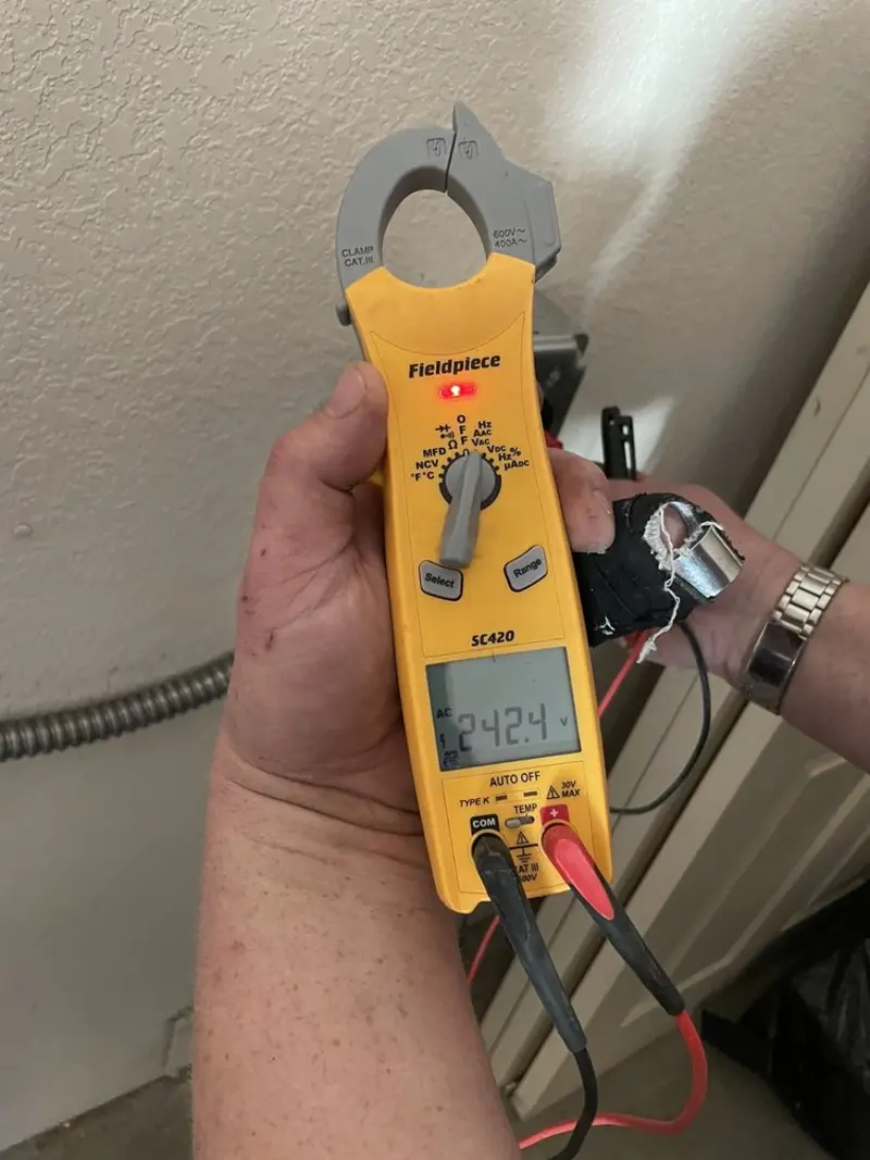 Voltage testing with clamp meter during Whole House Surge Protector in North Canaan